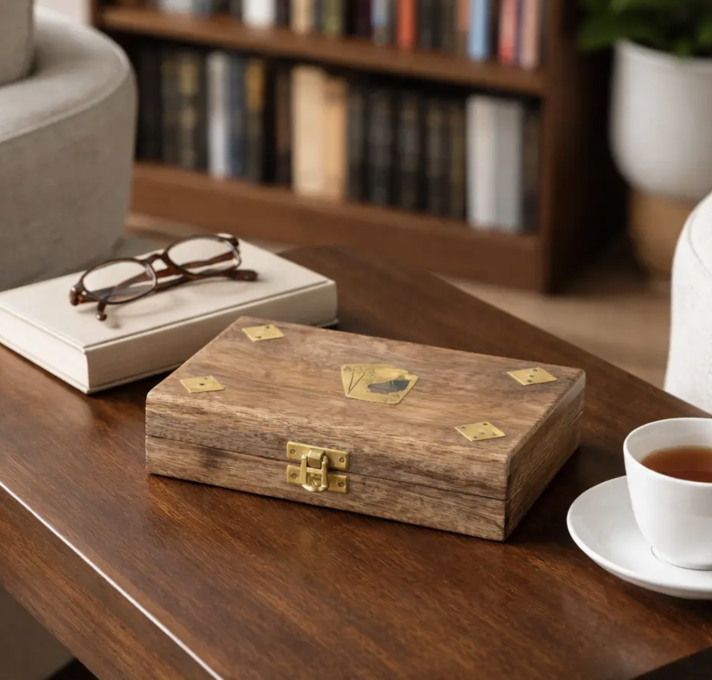 Closed brown wooden cards and dice box with gold-tone card and dice motifs